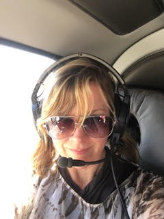 Becky Lukovic in a helicopter - Travel Agent Chatter